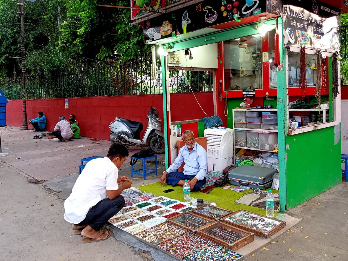 BUSINESS AS USUAL: Mukeed with his gems, as a customer peruses the collection