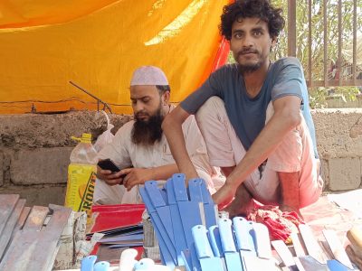 Shahnawaz, 28, with unsold knives and cleavers at the market