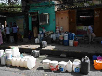Water Crisis: Residents of Vivekanand Camp in Chanakyapuri line up empty vessels even though the water tanker hasn’t arrived
