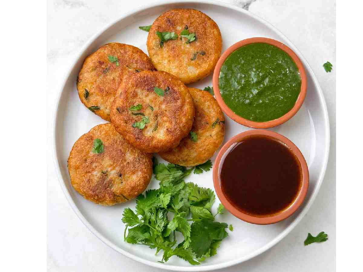 Aloo Tikki: Spicy potato patties shallow-fried until crispy, served with tamarind chutney