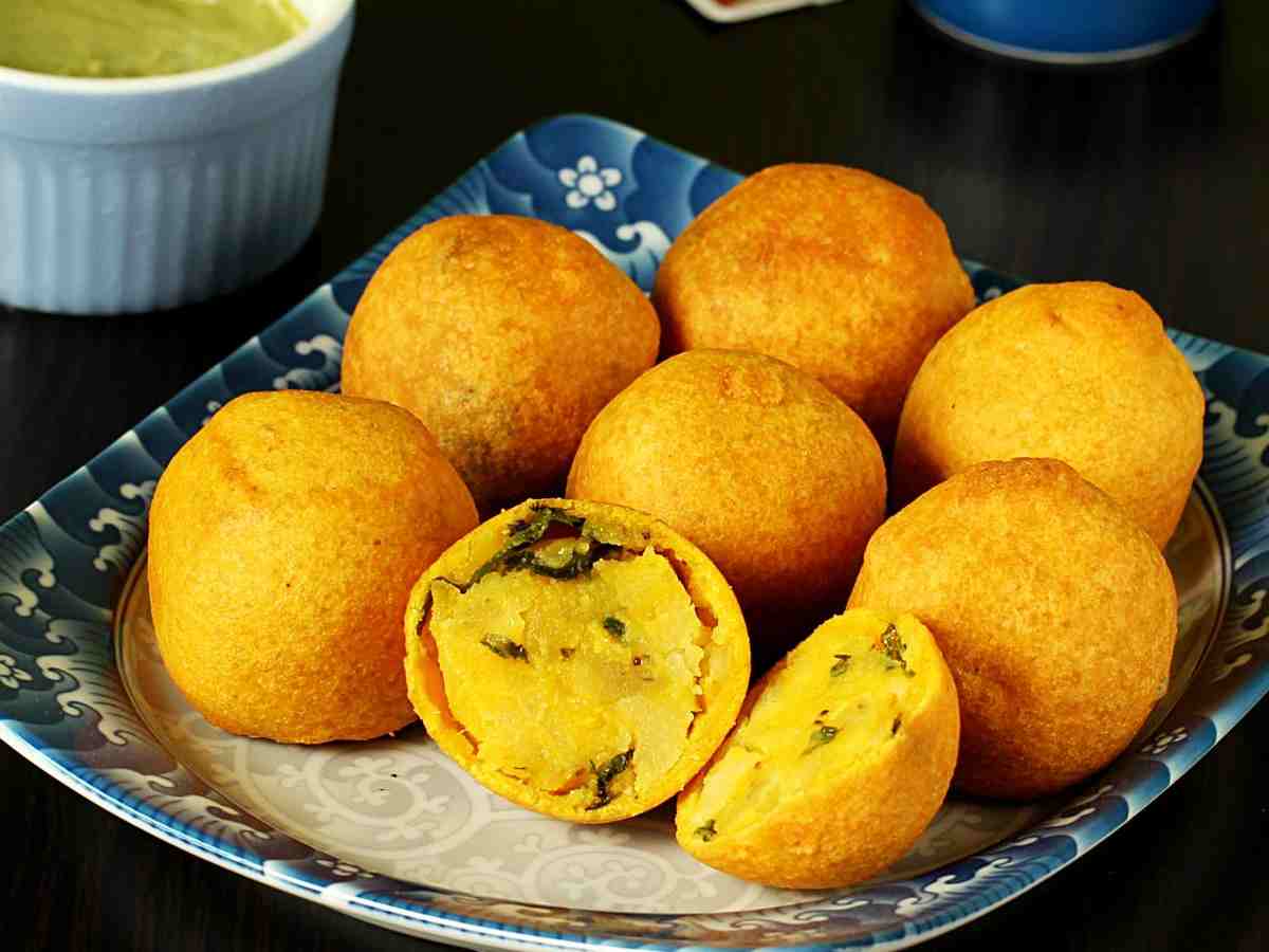 Batata Vada: Mashed potatoes mixed with spices, coated in gram flour batter, and deep-fried