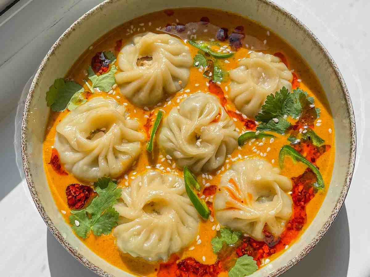 Jhol Momos: Steamed momos served in a hot, spicy soup for a comforting dish