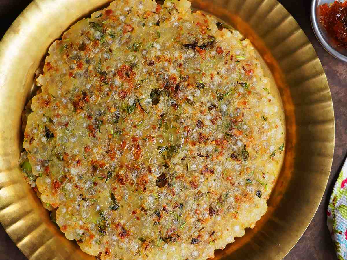 Sabudana Thalipeeth is a savoury pancake that is both nutritious and tasty. Mix soaked sabudana, mashed potatoes, crushed peanuts, green chilies, cumin seeds, and salt. Take a portion of the mixture and flatten it into a pancake. Heat oil in a pan and cook the pancake until it is golden brown on both sides. Serve this flavourful thalipeeth with yogurt or chutney.