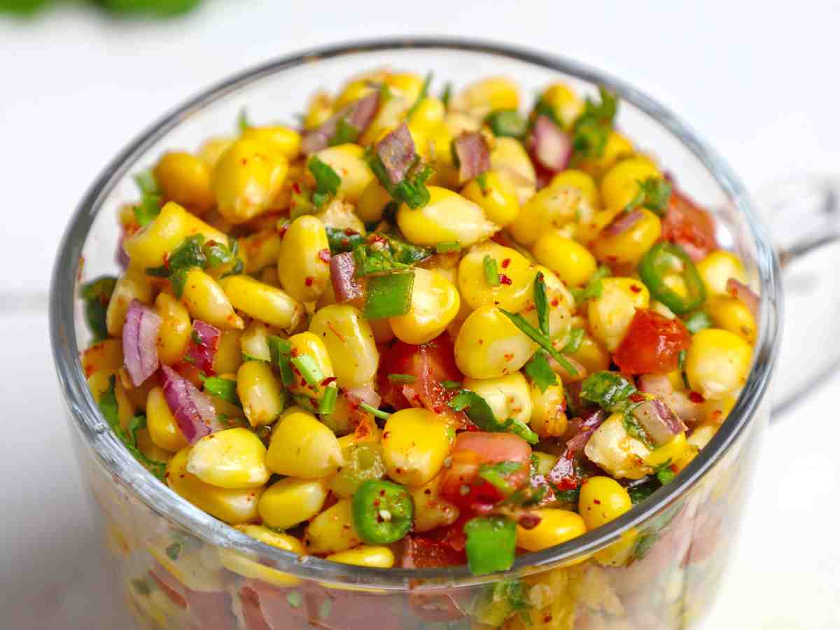 Spicy Corn Chaat: Fresh corn kernels mixed with spices, lemon juice, and chopped vegetables for a tangy treat