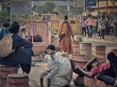 A Moment’s Respite: A boy sits atop the waste his family collects, enjoying an ice cream while his family rests nearby. In this brief moment of sweetness, his face reveals a rare glimpse of contentment amid a life of hardship