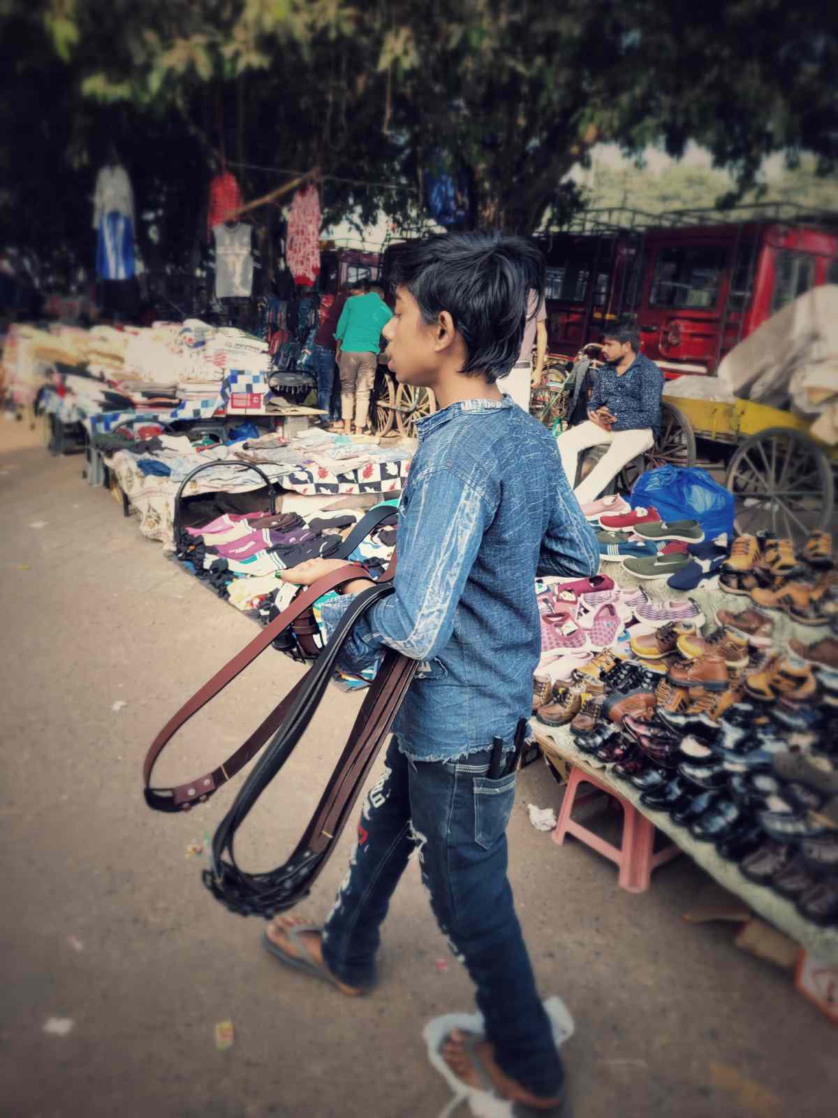 Strength Beyond Years: A young boy stands on the streets of Delhi, selling belts to help his family survive. Each sale is a small act of resilience in his fight for a better life