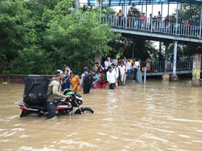 Delhi rain floods streets, disrupts traffic; locals use makeshift raft to ferry schoolchildren