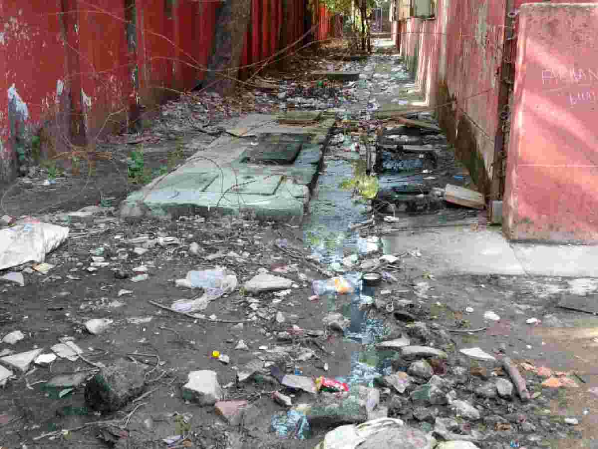 Garbage piled up behind the school building has turned into a mosquito breeding ground