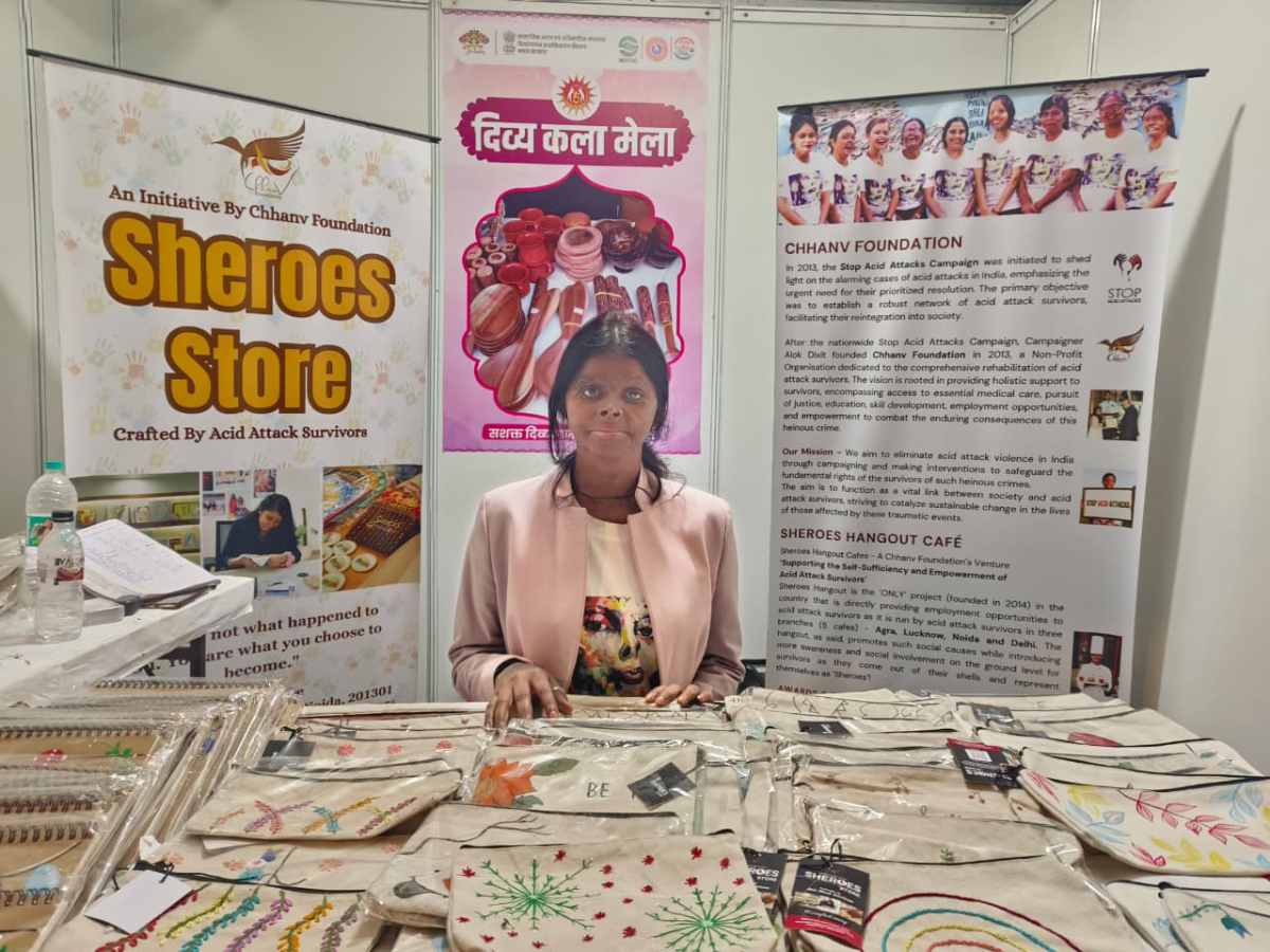 An acid attack survivor sells handmade diaries and bags at Divya Kala Mela 2025