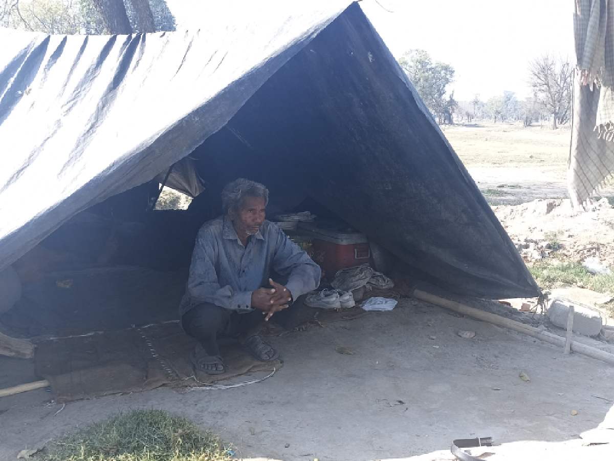 Moin Ali sits inside his makeshift tenement