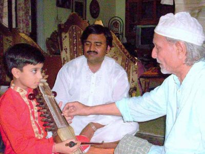 A young Nabeel Khan learning the art of sarangi from his grandfather