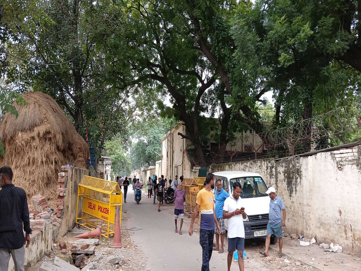 Despite the impending doom of demolition hanging, residents of Race Course Road slums remain engrossed in their betting hustle