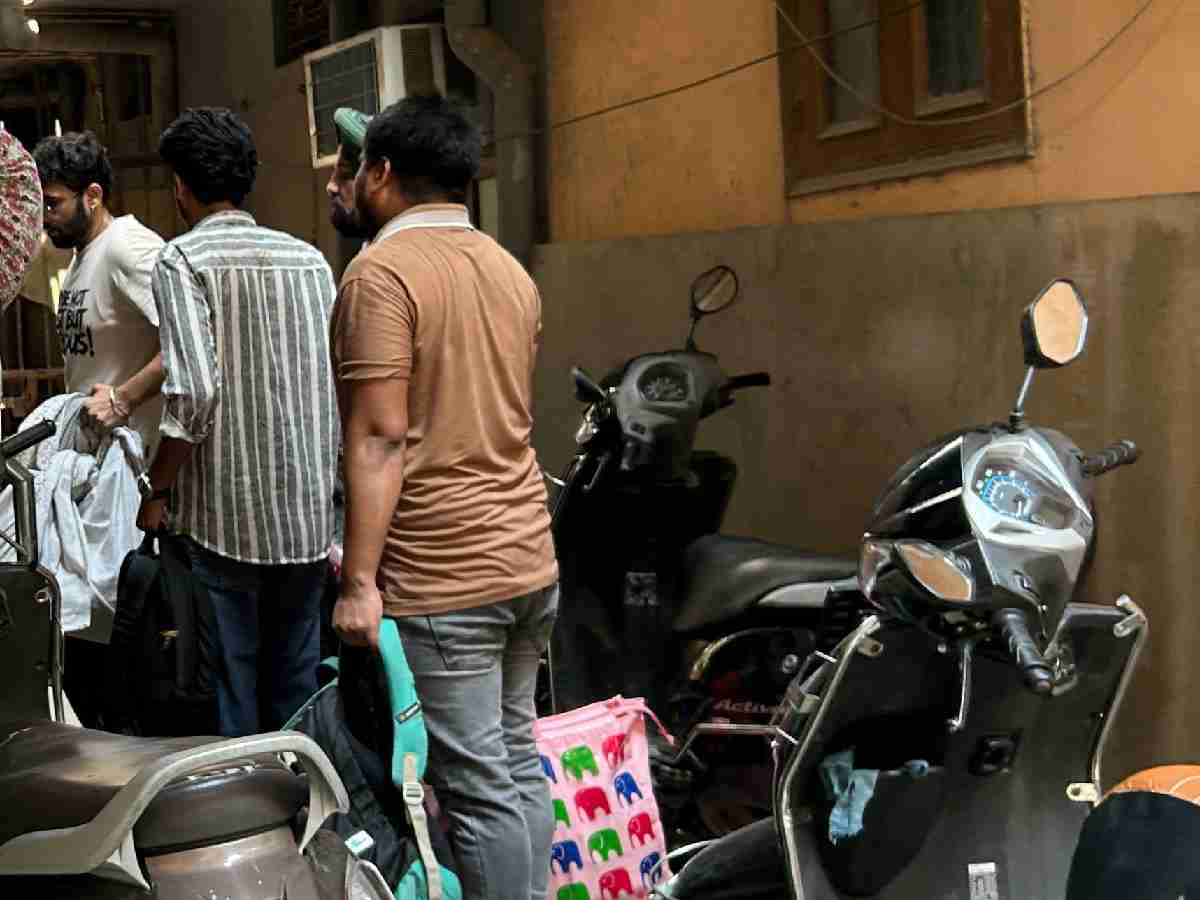 Students leave their Satya Niketan accommodationwith their belongings following the building collapse