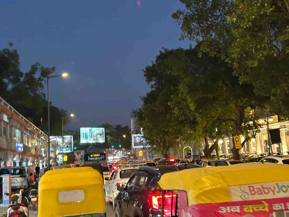Traffic moves through New Delhi amid restrictions imposed during the BRICS Summit, with congestion visible on roads around the central market area.
