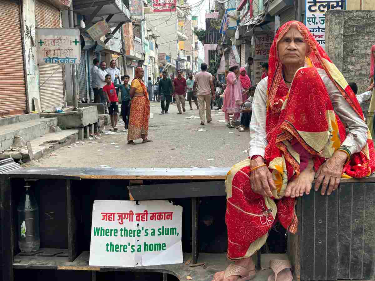 A signboard outside a house in Aali village says: ‘Where there’s a slum, there’s a home’